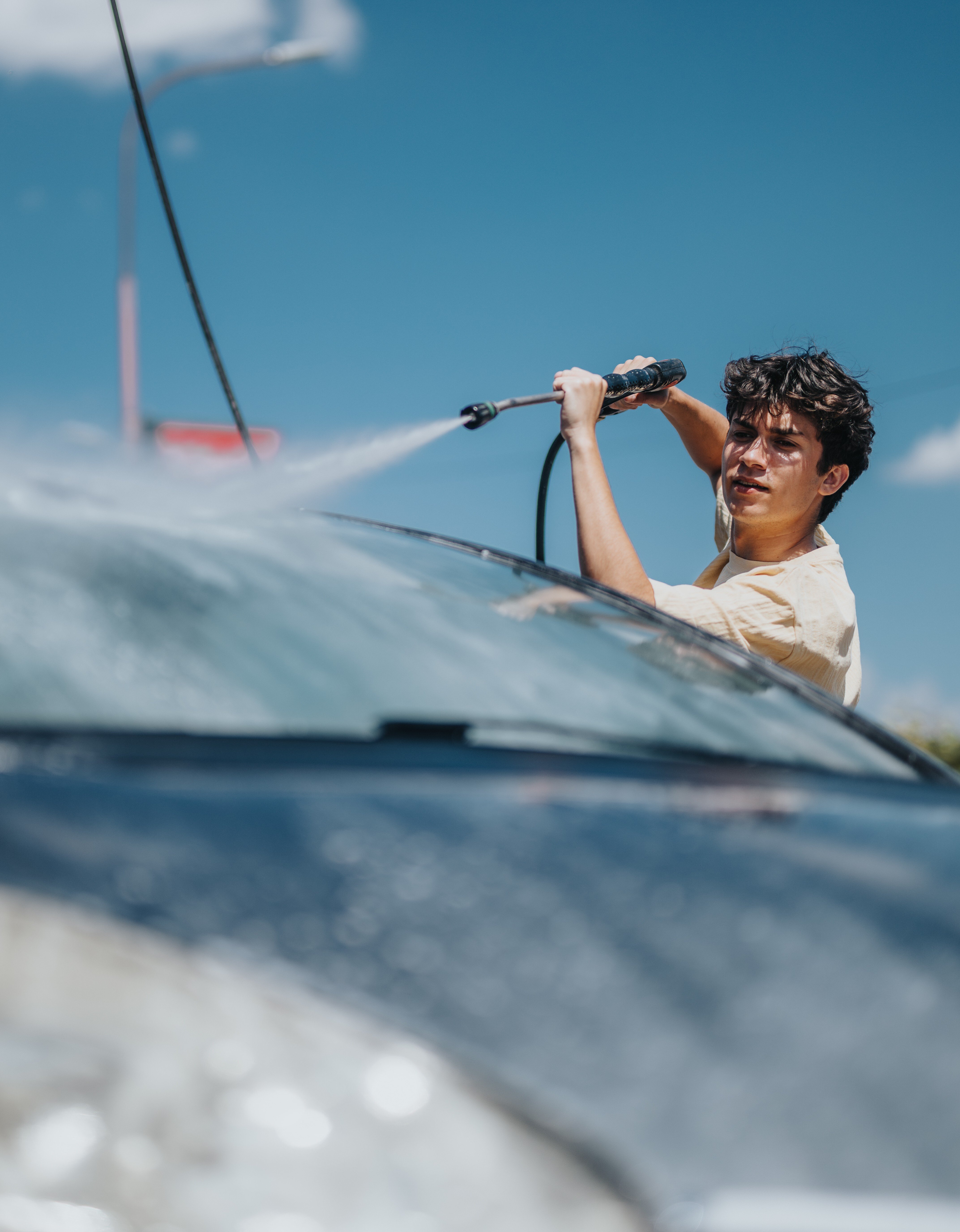 teen jet washing a car