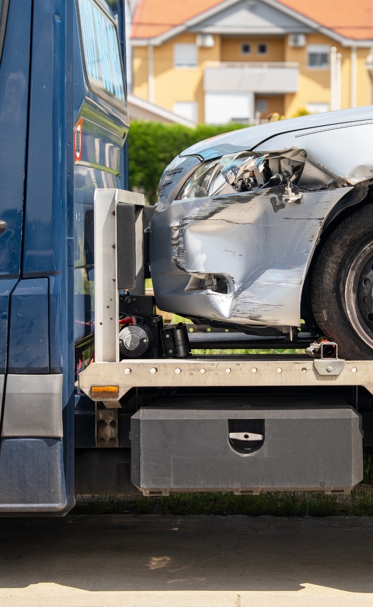 damaged car being towed