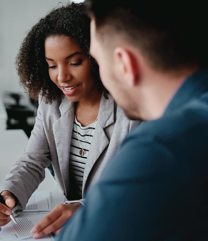 woman going over document with man