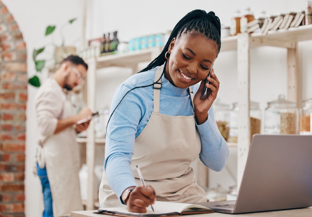 black-woman-cashier-notes-and-phone-call-with-net-2023-11-27-05-23-51-utc