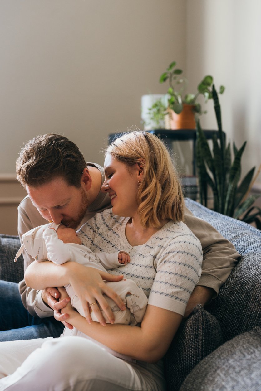 couple-on-couch-with-baby