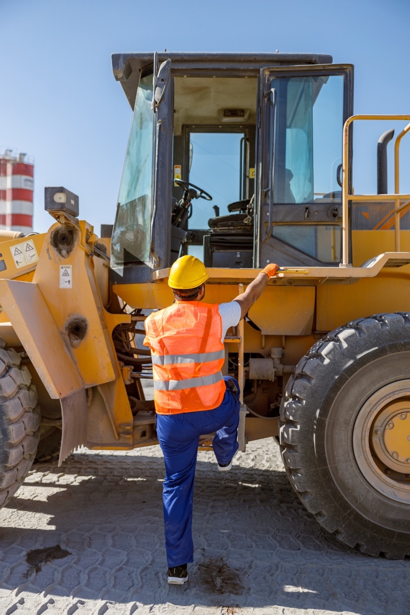 experienced-construction-worker-using-truck-at-fac-2023-11-27-04-54-30-utc