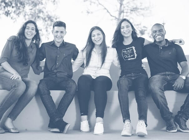 Coworkers sitting together and smiling outside. Coworkers sitting together and smiling outside.