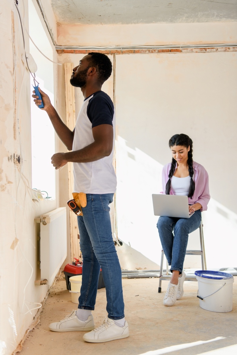side-view-of-african-american-man-painting-wall-wh-2023-11-27-05-11-07-utc